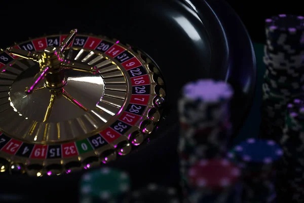 Live dealer managing the wheel and table position Dealer at roulette table
